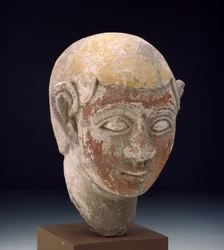 Painted sandstone head of a ba-statue